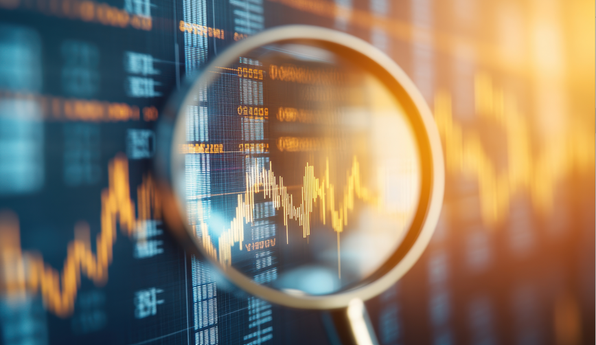 Financial chart being analyzed through a magnifying glass on a screen